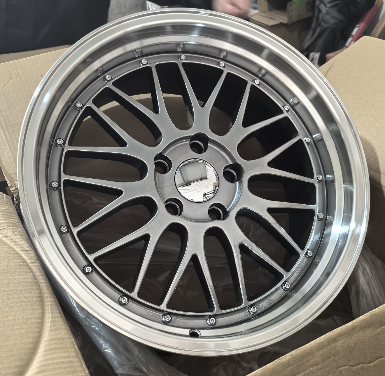 Heritage multi-spoke aftermarket wheel with a dark metallic face and stepped polished lip